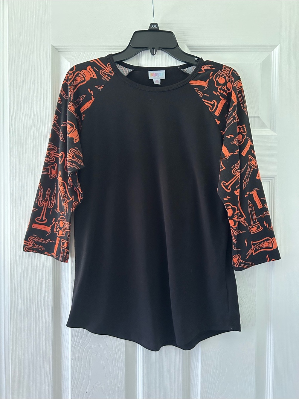 LuLaRoe Black top with Orange Printed Raglan Sleeves